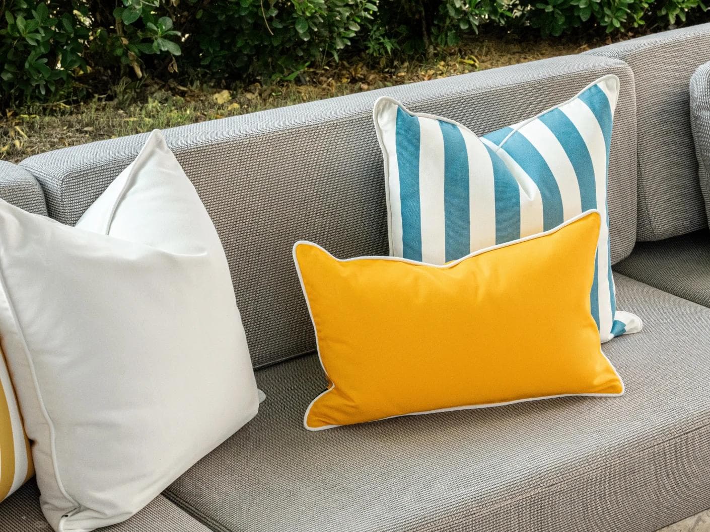Elio Bundle cushion in turquoise, yellow and ivory, shown in a lifestyle left view as image 4