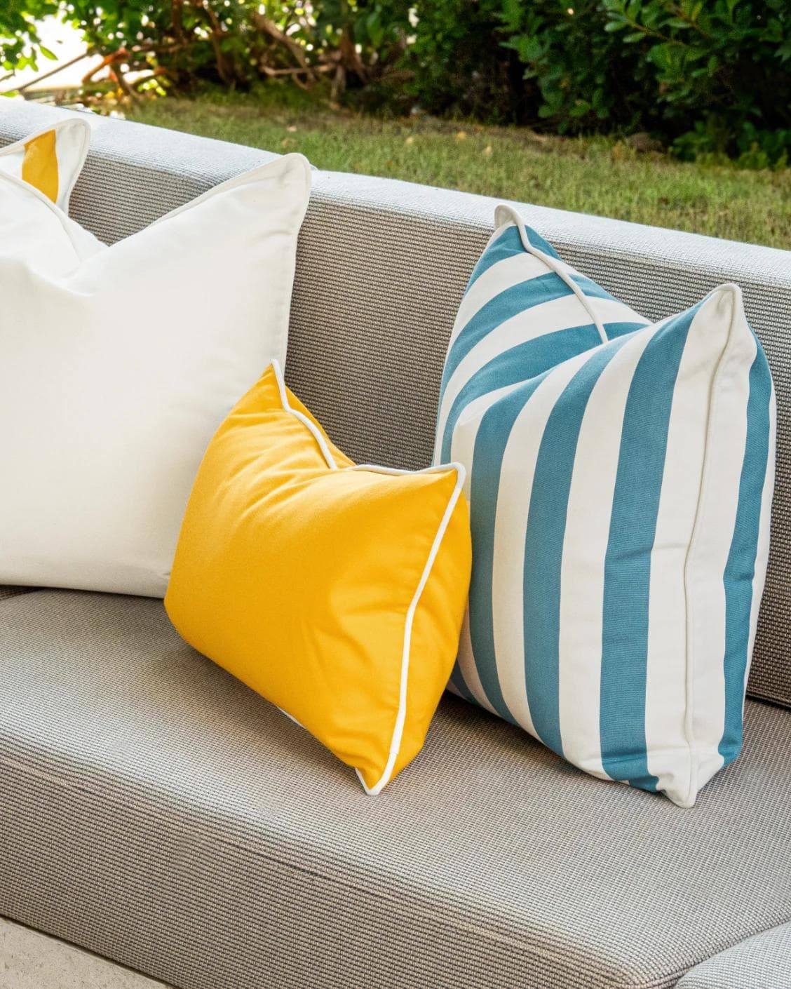 Elio Bundle cushion in turquoise, yellow and ivory, shown in a lifestyle right view as image 6