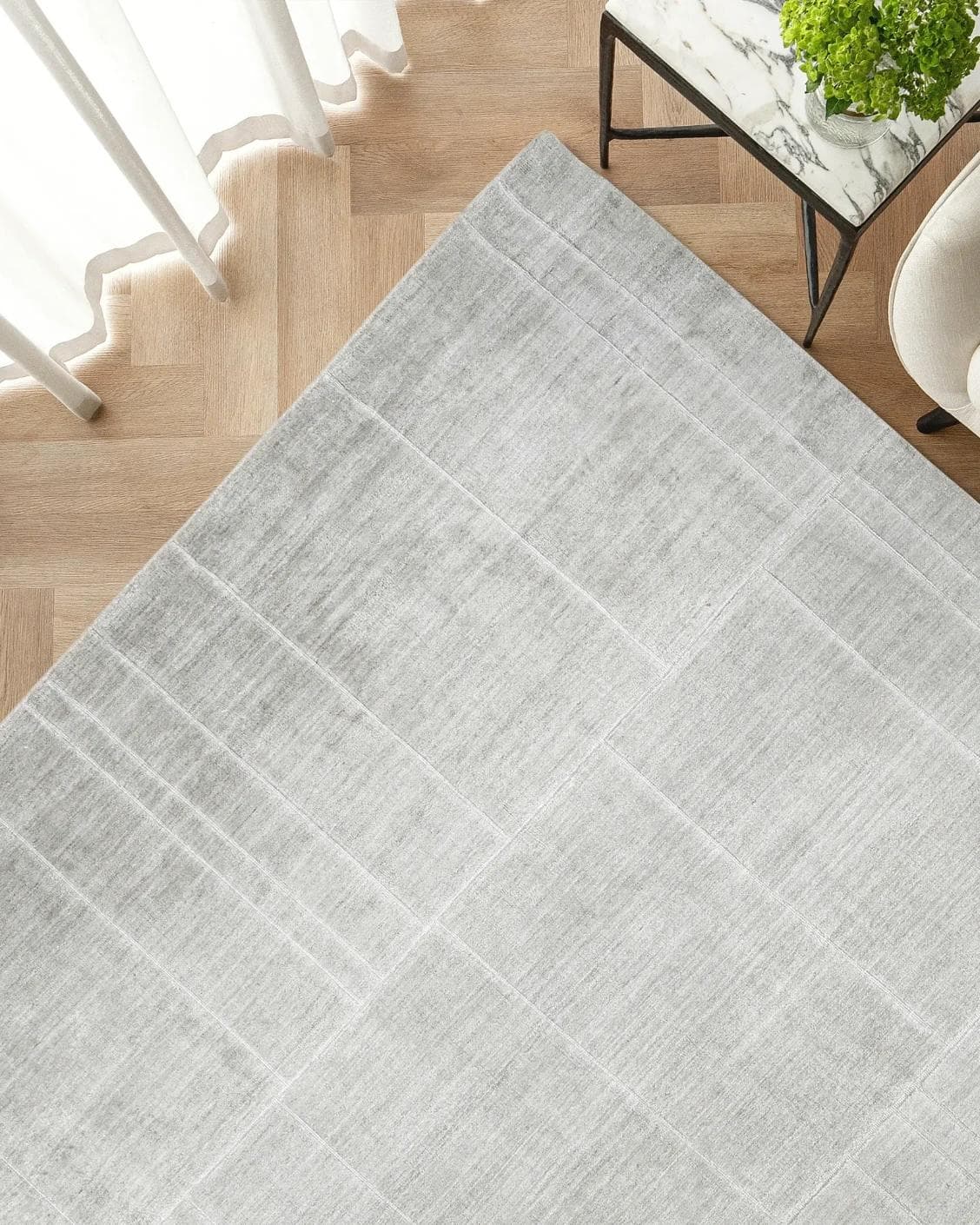 Elliot Ashton carpet in grey and silver, shown in a lifestyle top view as image 2