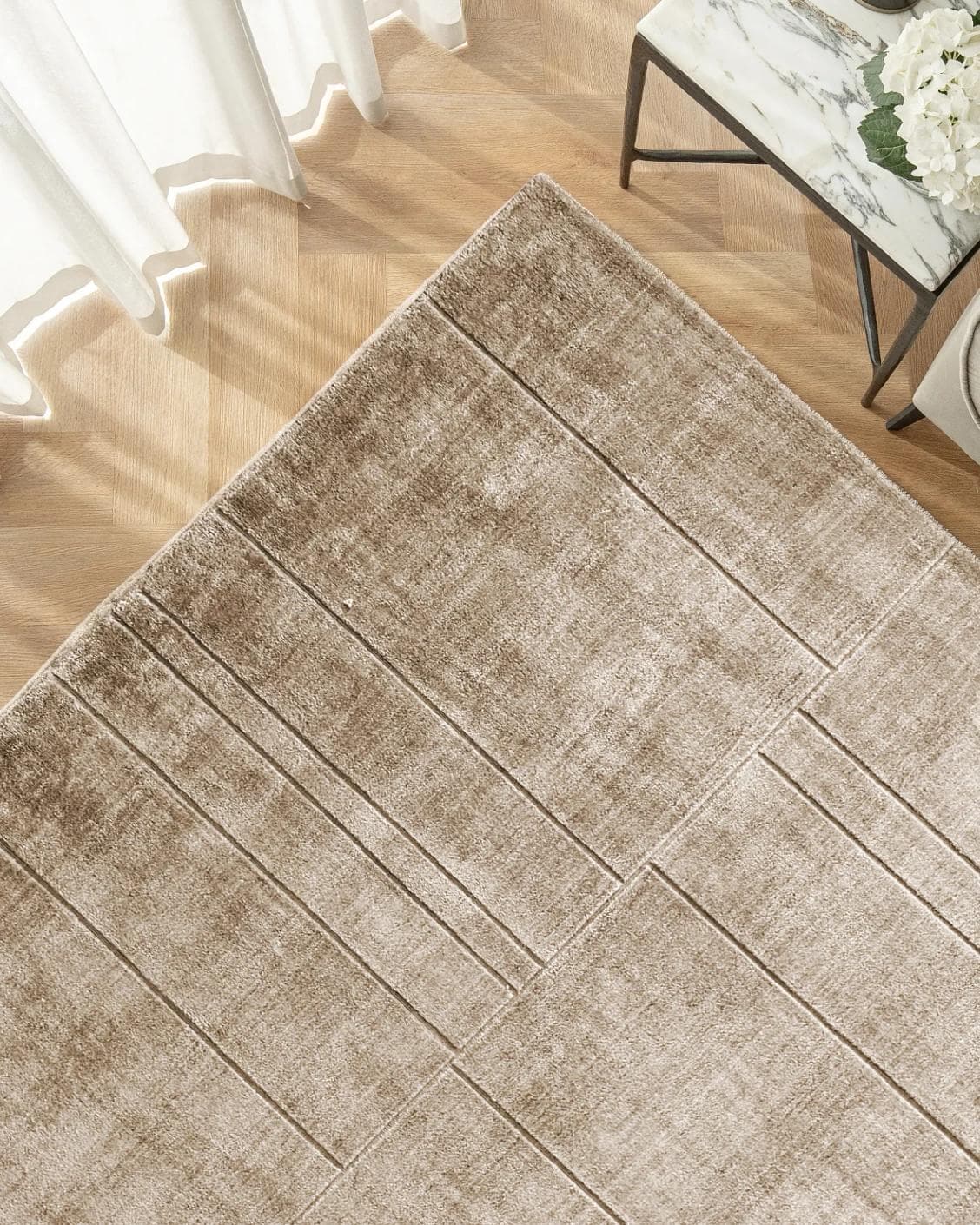 Elliot Sandy carpet in beige and taupe, shown in a lifestyle top view as image 2