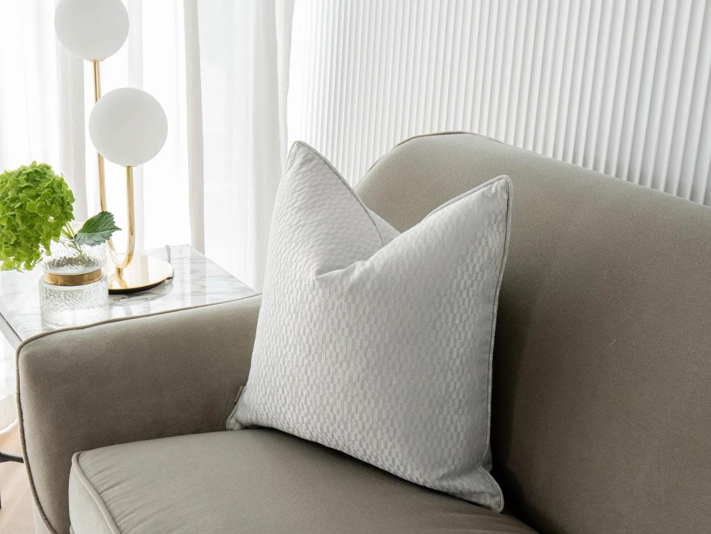Elodie Bianca cushion in silver, shown in a lifestyle front view as image 2