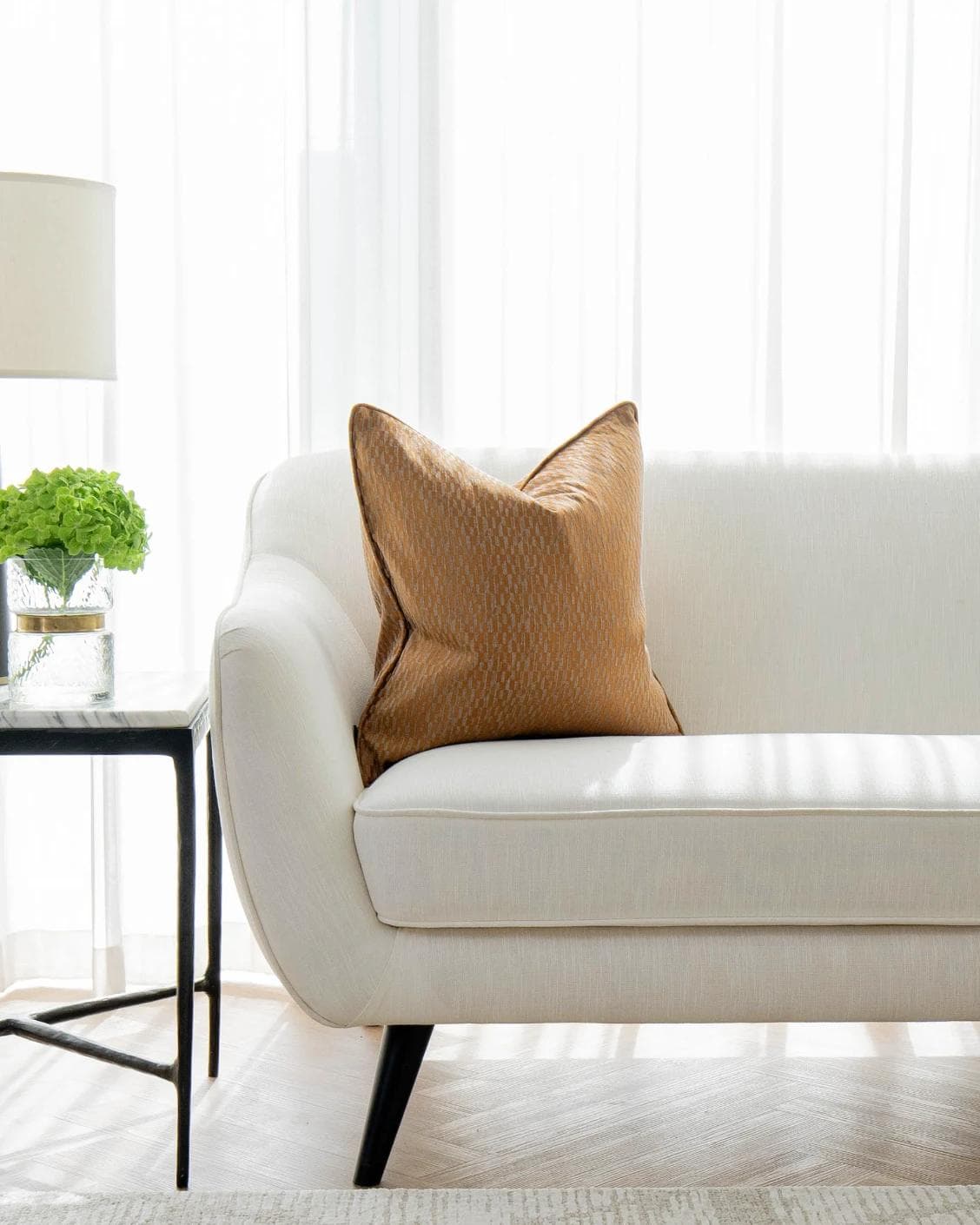 Elodie Hodler cushion in silver and orange, shown in a lifestyle front view as image 4