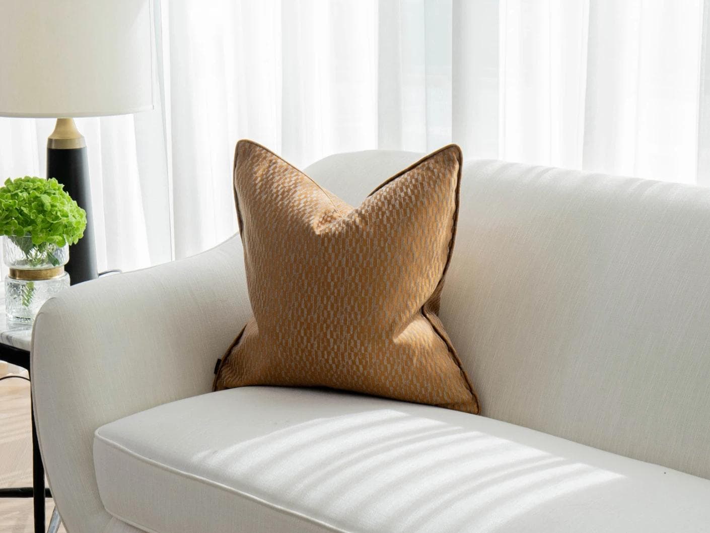 Elodie Hodler cushion in silver and orange, shown in a lifestyle front view as image 2