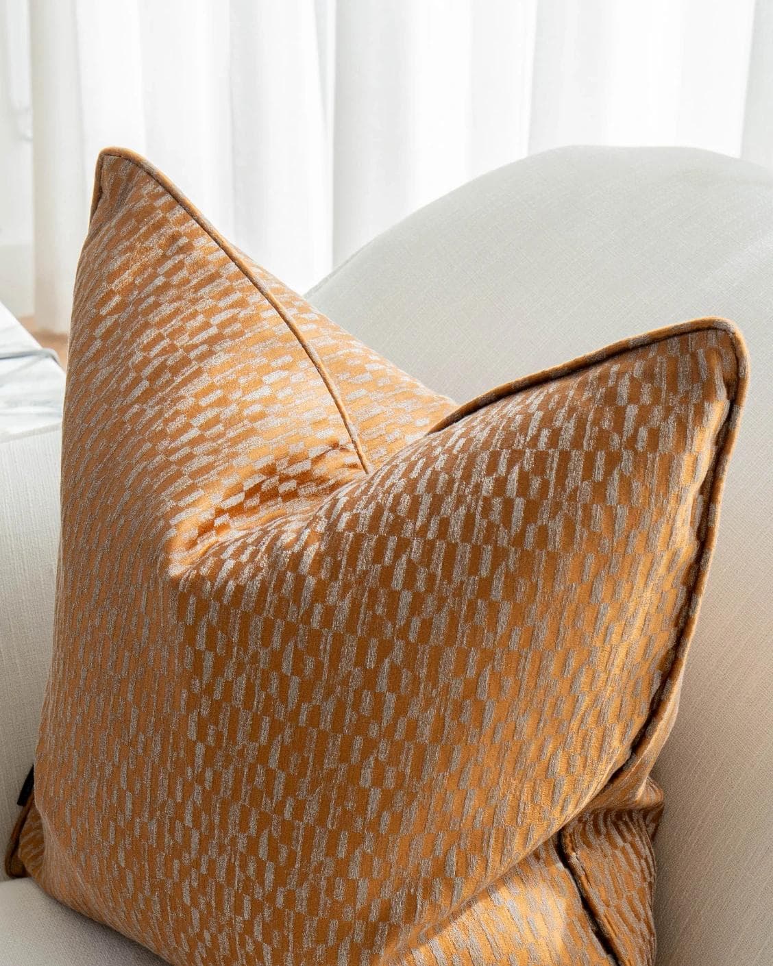 Elodie Hodler cushion in silver and orange, shown in a lifestyle top view as image 5