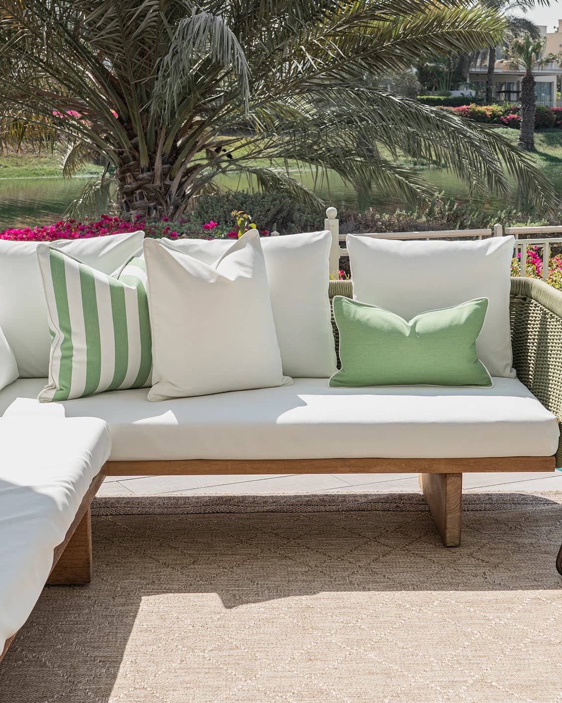 Elovie Bundle cushion in green and ivory, shown in a lifestyle front view as image 4