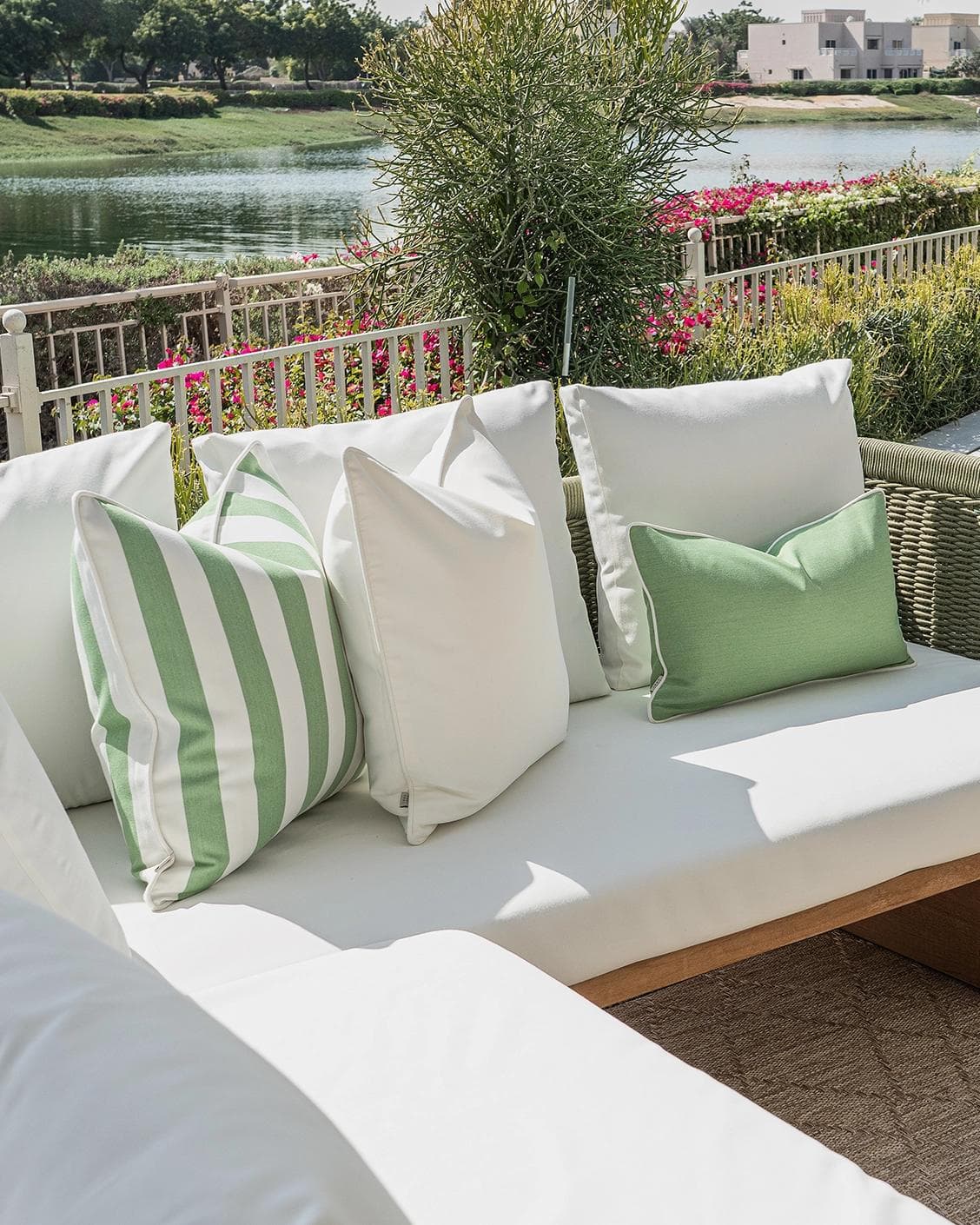 Elovie Bundle cushion in green and ivory, shown in a lifestyle left view as image 2