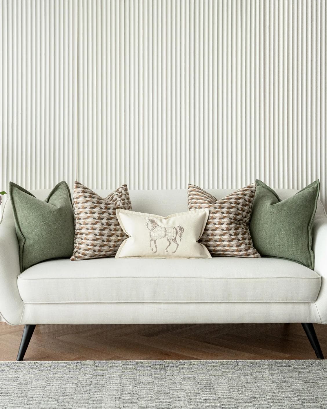 Emmanuela Bundle cushion in orange, beige, white and green, shown in a lifestyle front view as image 4