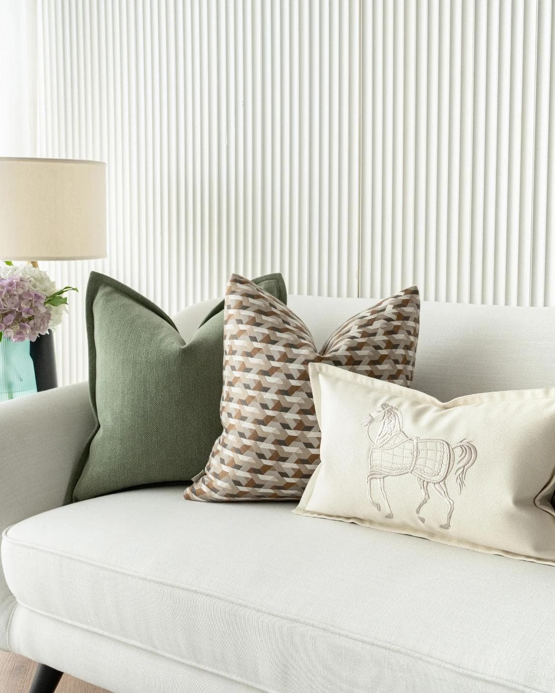 Emmanuela Bundle cushion in orange, beige, white and green, shown in a lifestyle right view as image 5