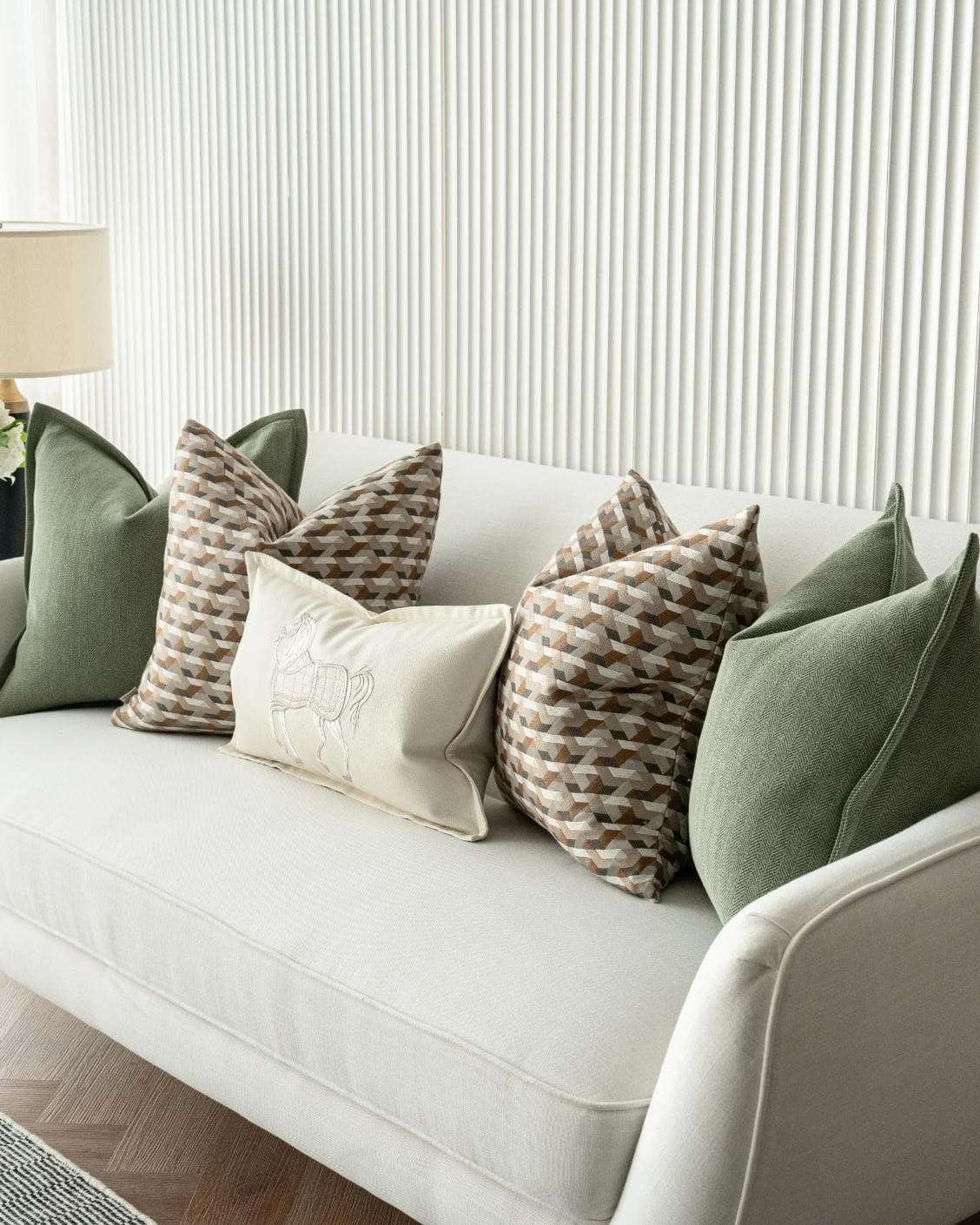 Emmanuela Bundle cushion in orange, beige, white and green, shown in a lifestyle right view as image 6