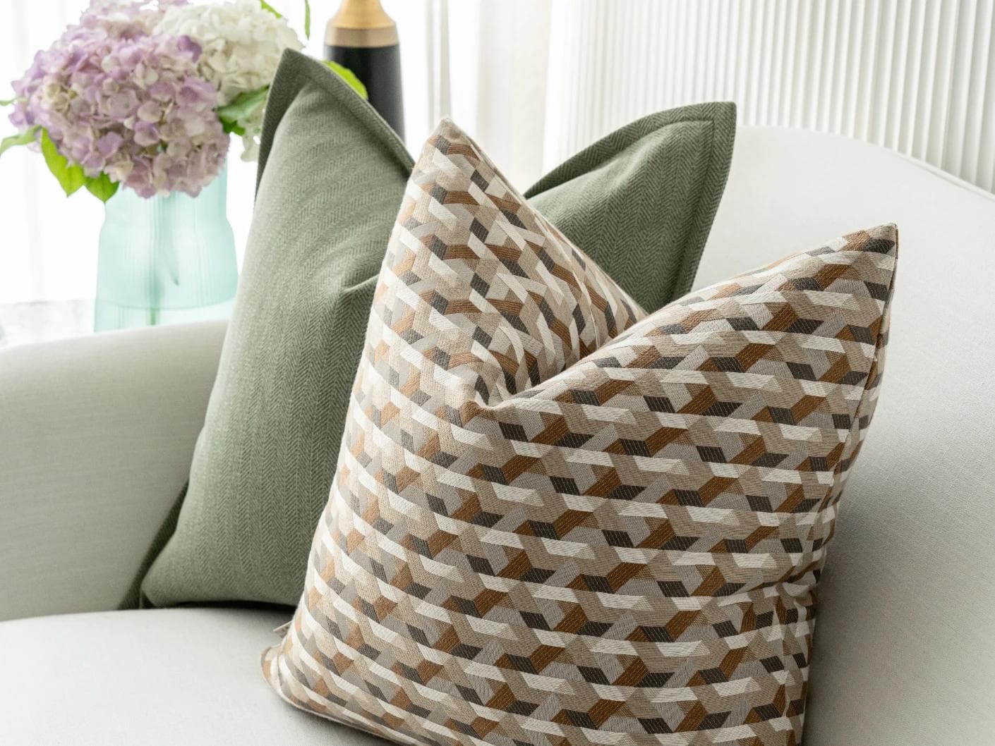 Emmanuela Bundle cushion in orange, beige, white and green, shown in a lifestyle right view as image 7