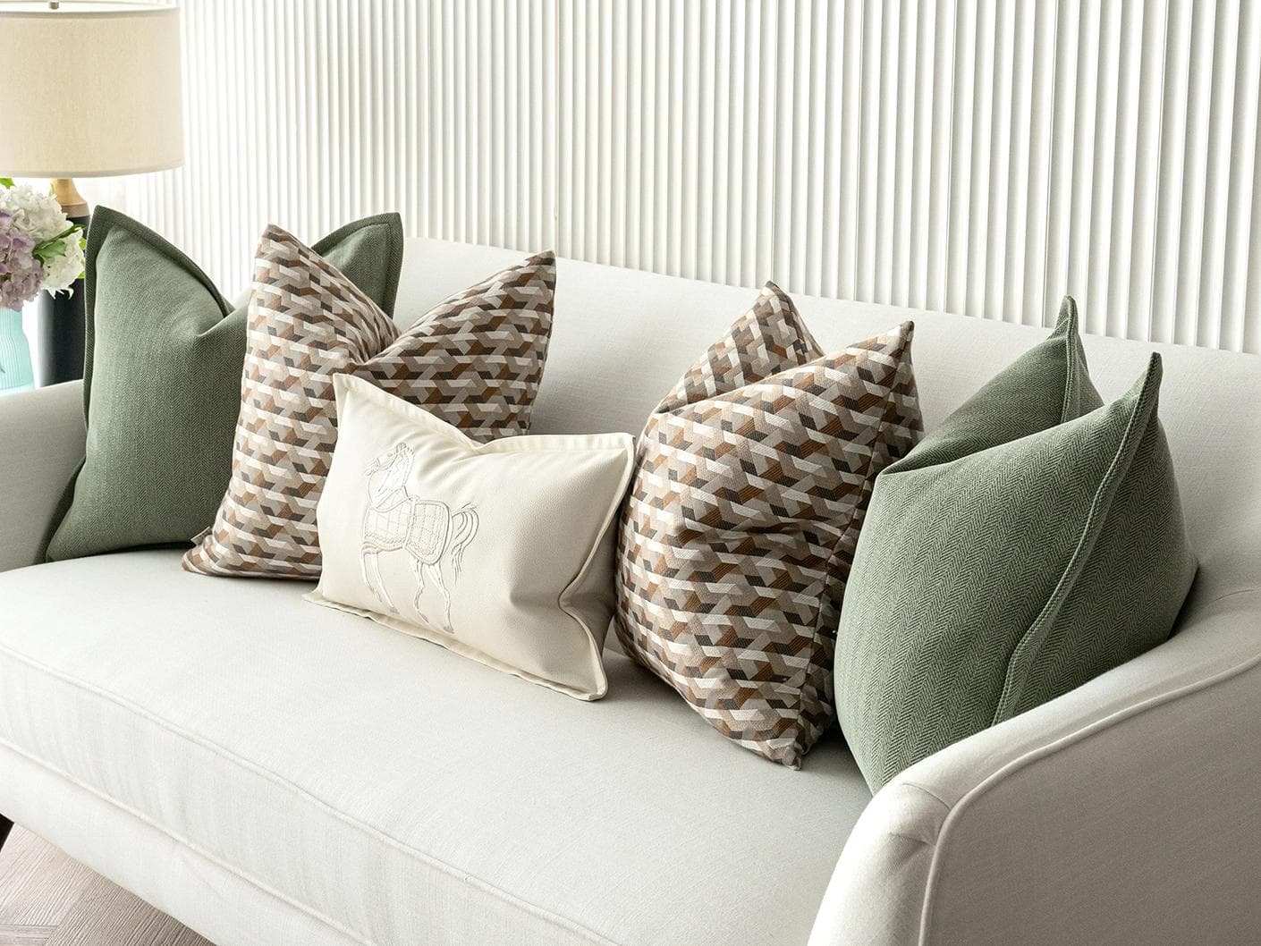 Emmanuela Bundle cushion in orange, beige, white and green, shown in a lifestyle right view as image 6
