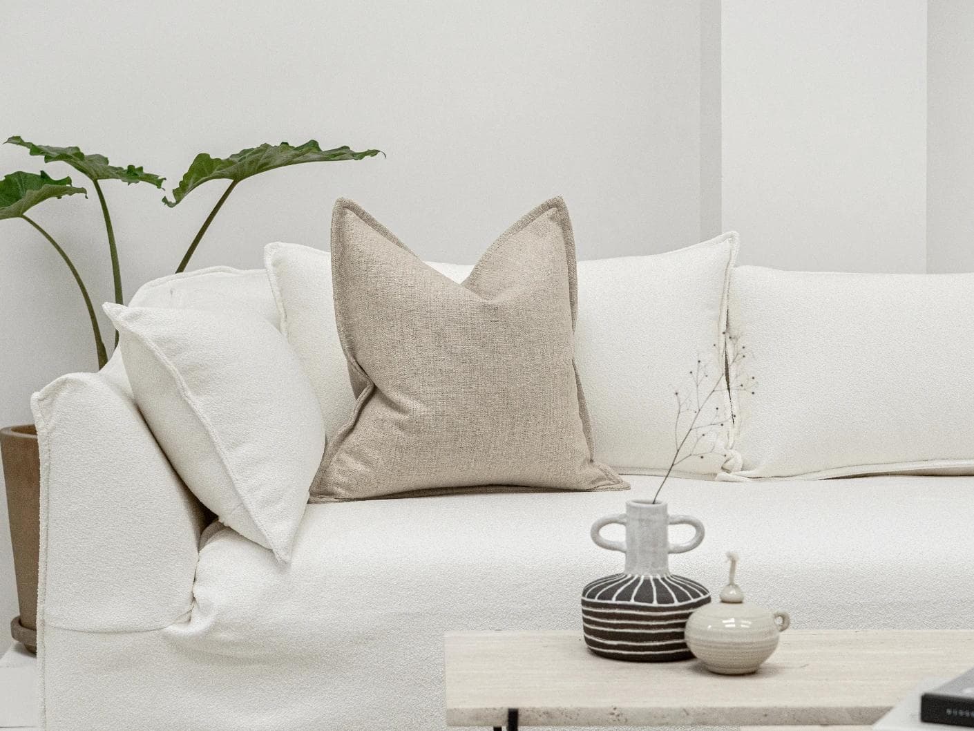 Emmett Alba cushion in beige, shown in a lifestyle front view as image 4