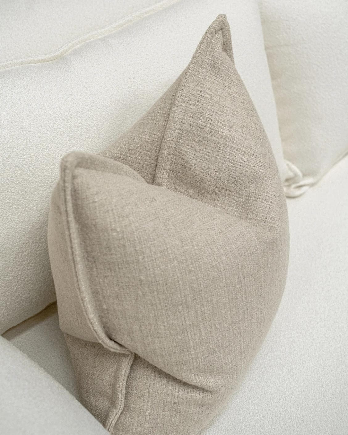 Emmett Alba cushion in beige, shown in a lifestyle top view as image 5