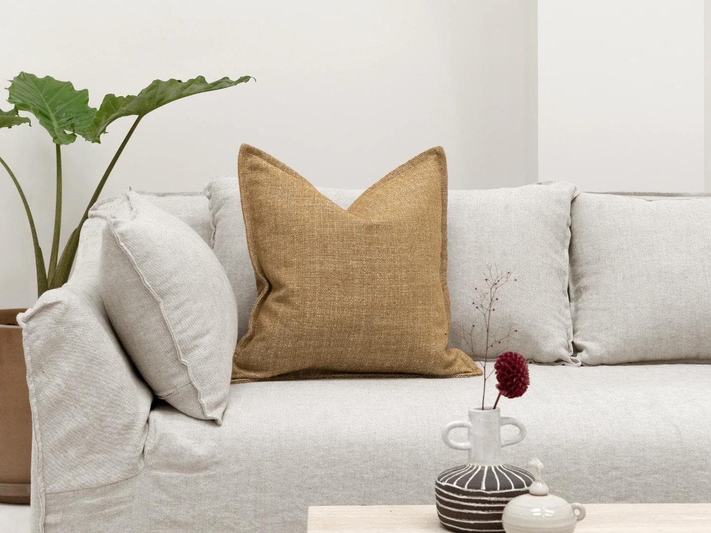 Emmett Dijon cushion in beige, shown in a lifestyle front view as image 4