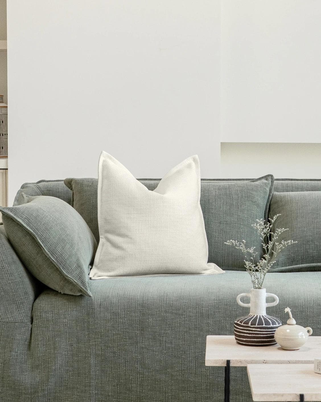 Emmett Jasmine cushion in white, shown in a lifestyle front view as image 4