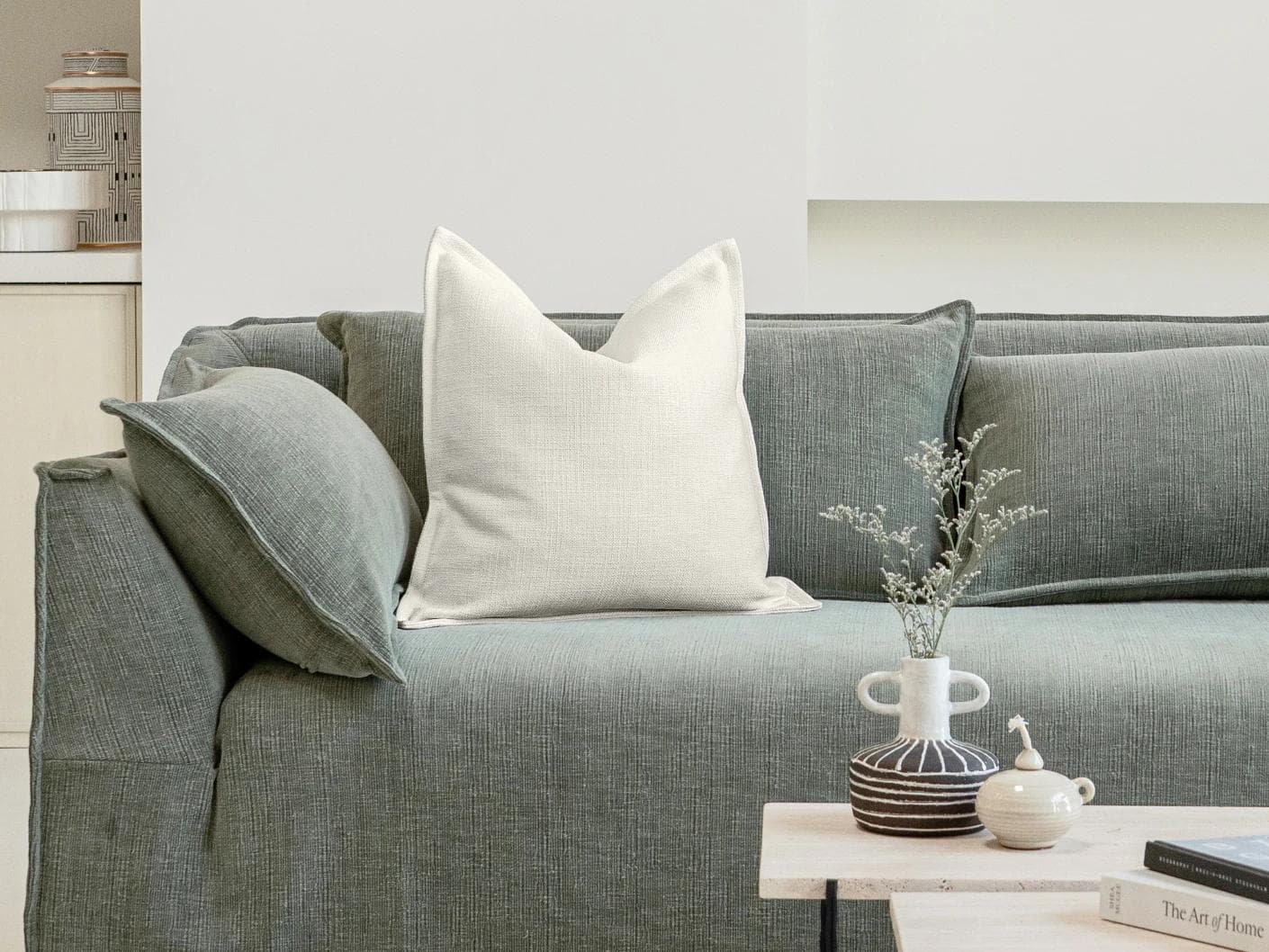 Emmett Jasmine cushion in white, shown in a lifestyle front view as image 4