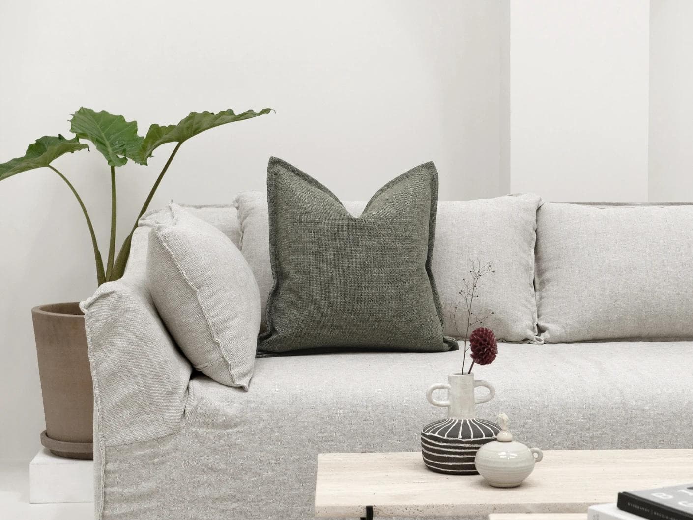 Emmett Olive cushion in green, shown in a lifestyle front view as image 4