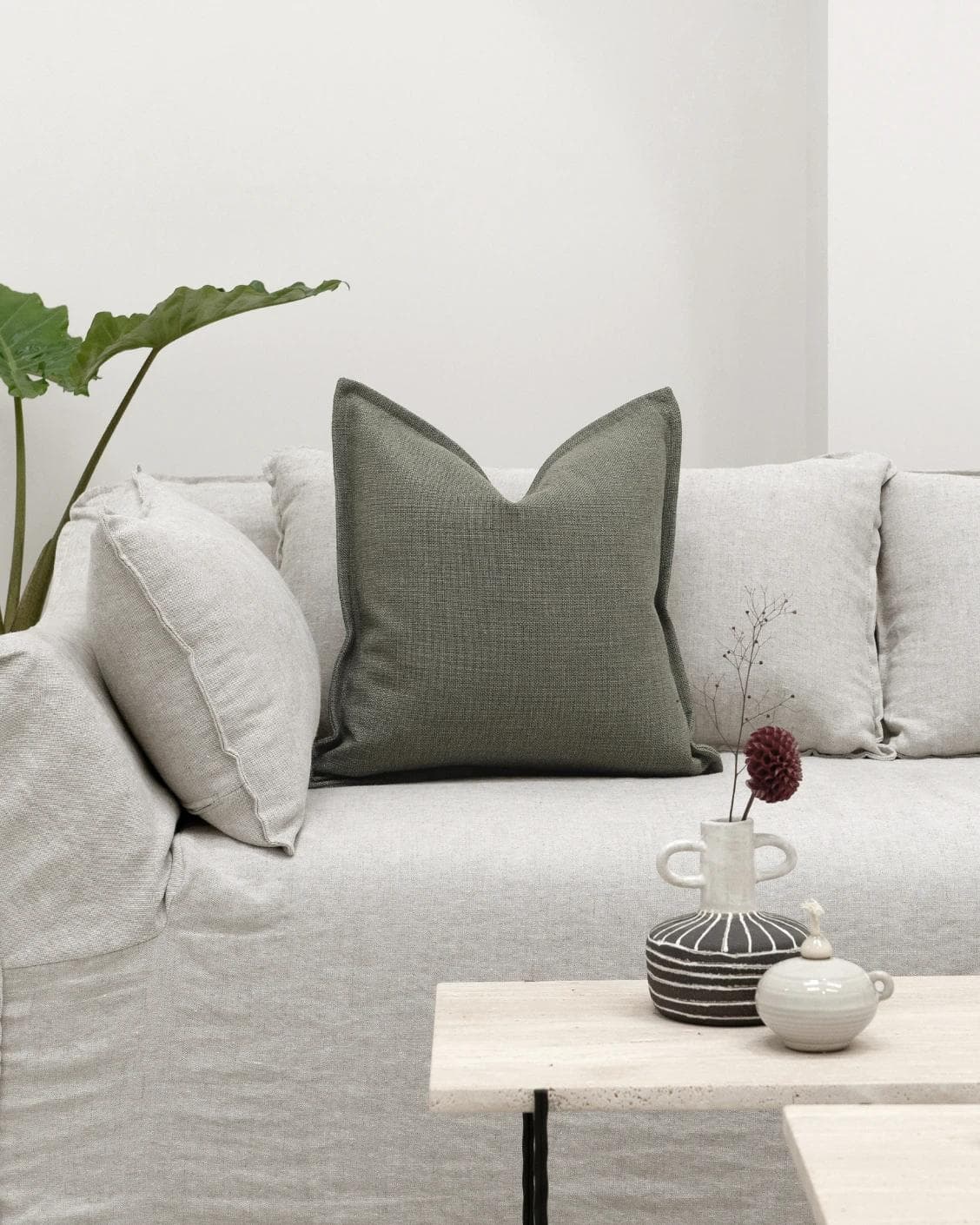 Emmett Olive cushion in green, shown in a lifestyle front view as image 4
