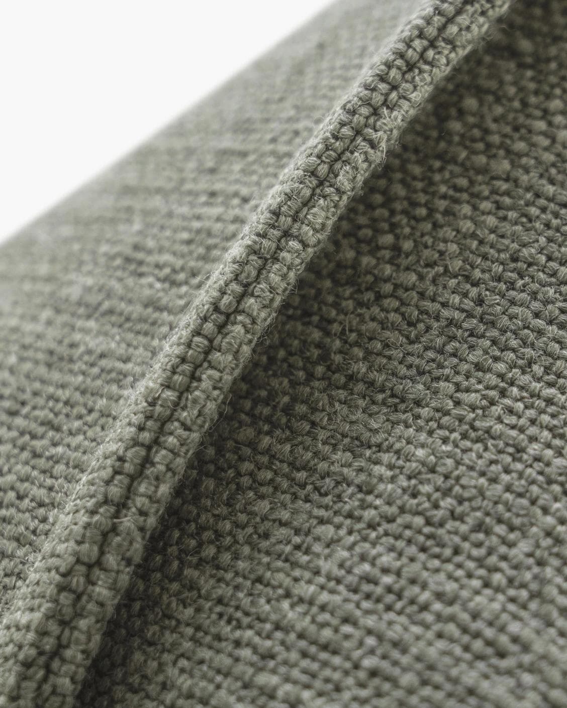 Emmett Olive cushion in green, shown in a product close-up as image 7