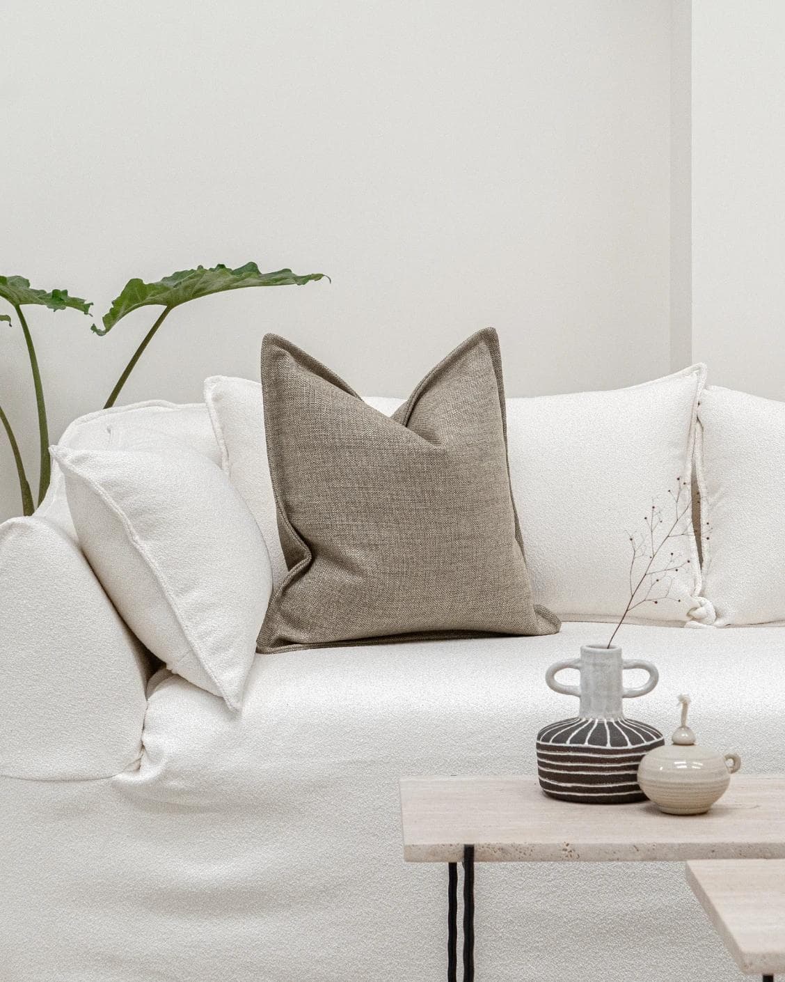 Emmett Quell cushion in taupe and grey, shown in a lifestyle front view as image 4