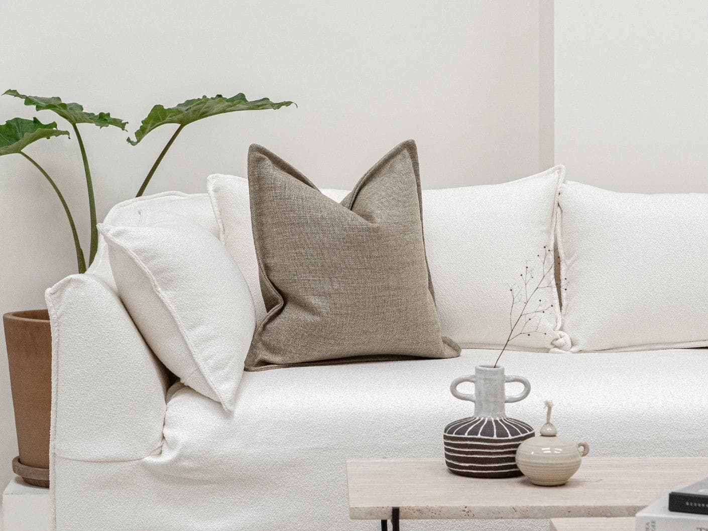 Emmett Quell cushion in taupe and grey, shown in a lifestyle front view as image 4