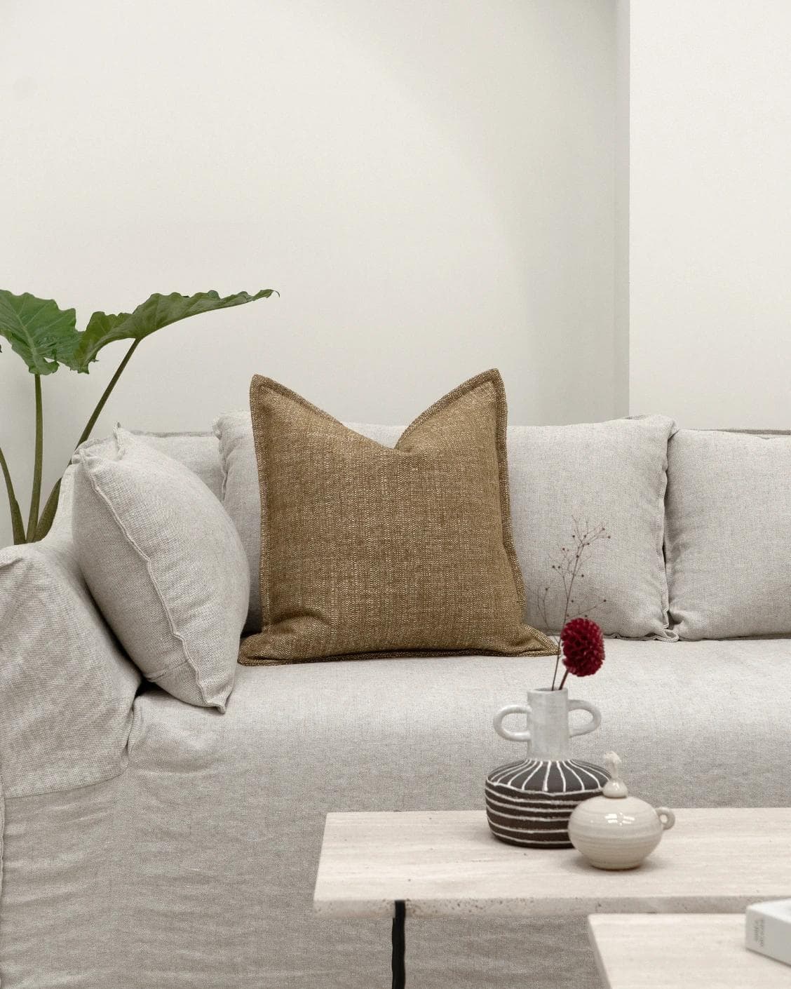 Emmett Tawna cushion in brown, shown in a lifestyle front view as image 4