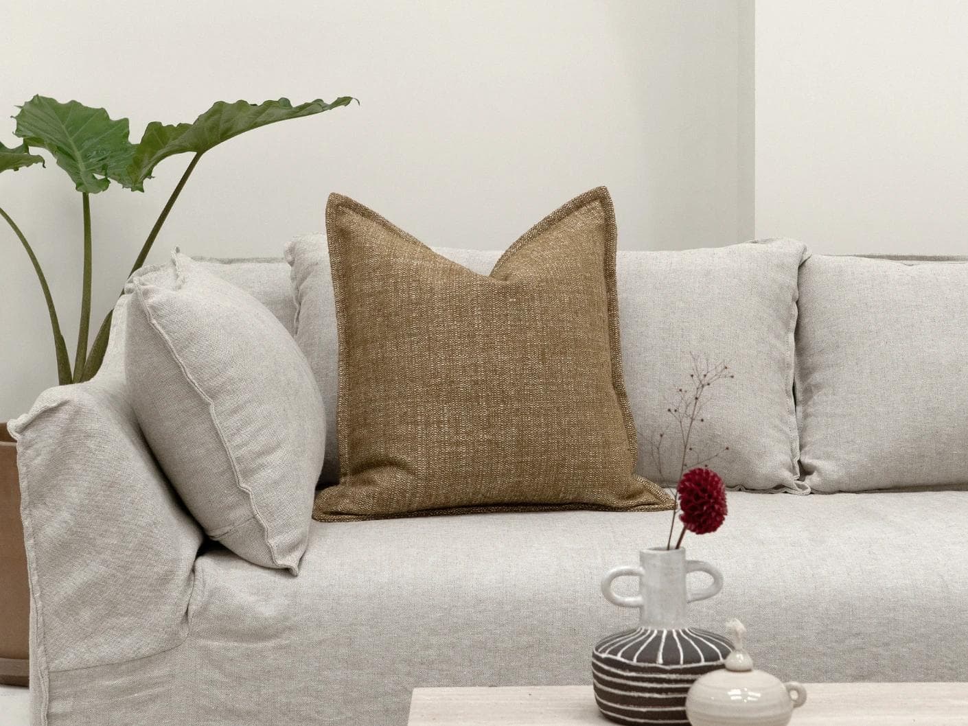 Emmett Tawna cushion in brown, shown in a lifestyle front view as image 4