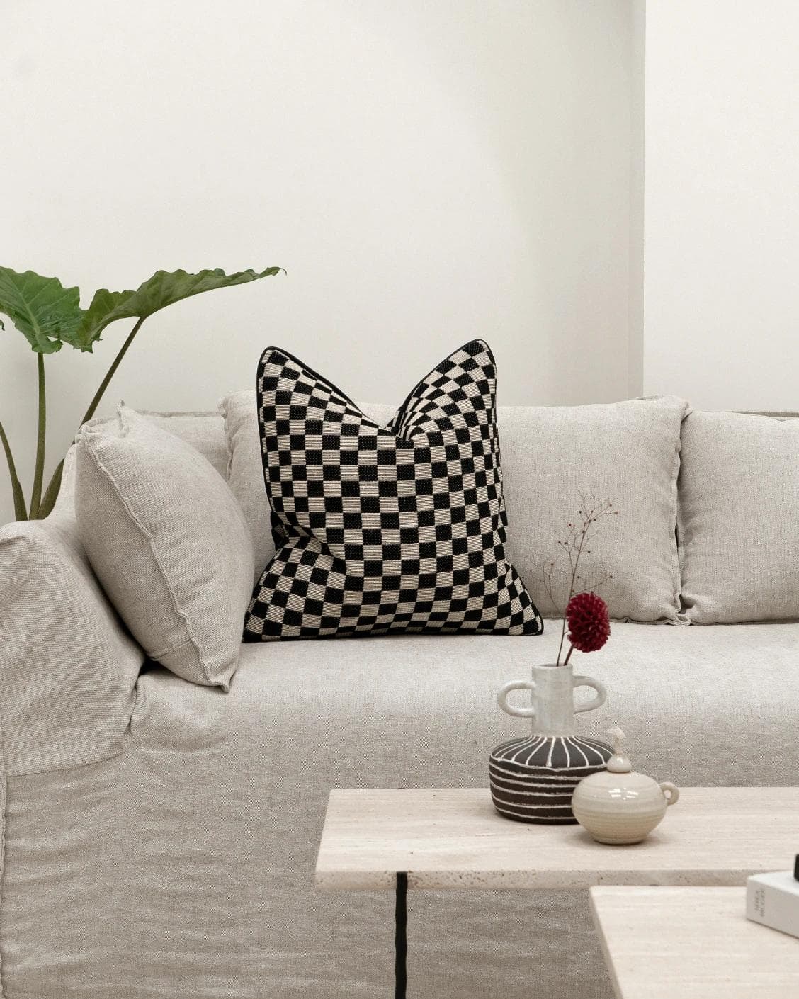 Enya Steele cushion in black and beige, shown in a lifestyle front view as image 3