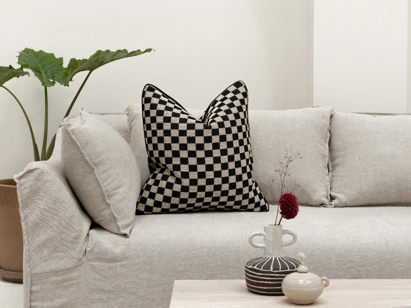 Enya Steele cushion in black and beige, shown in a lifestyle front view as image 3