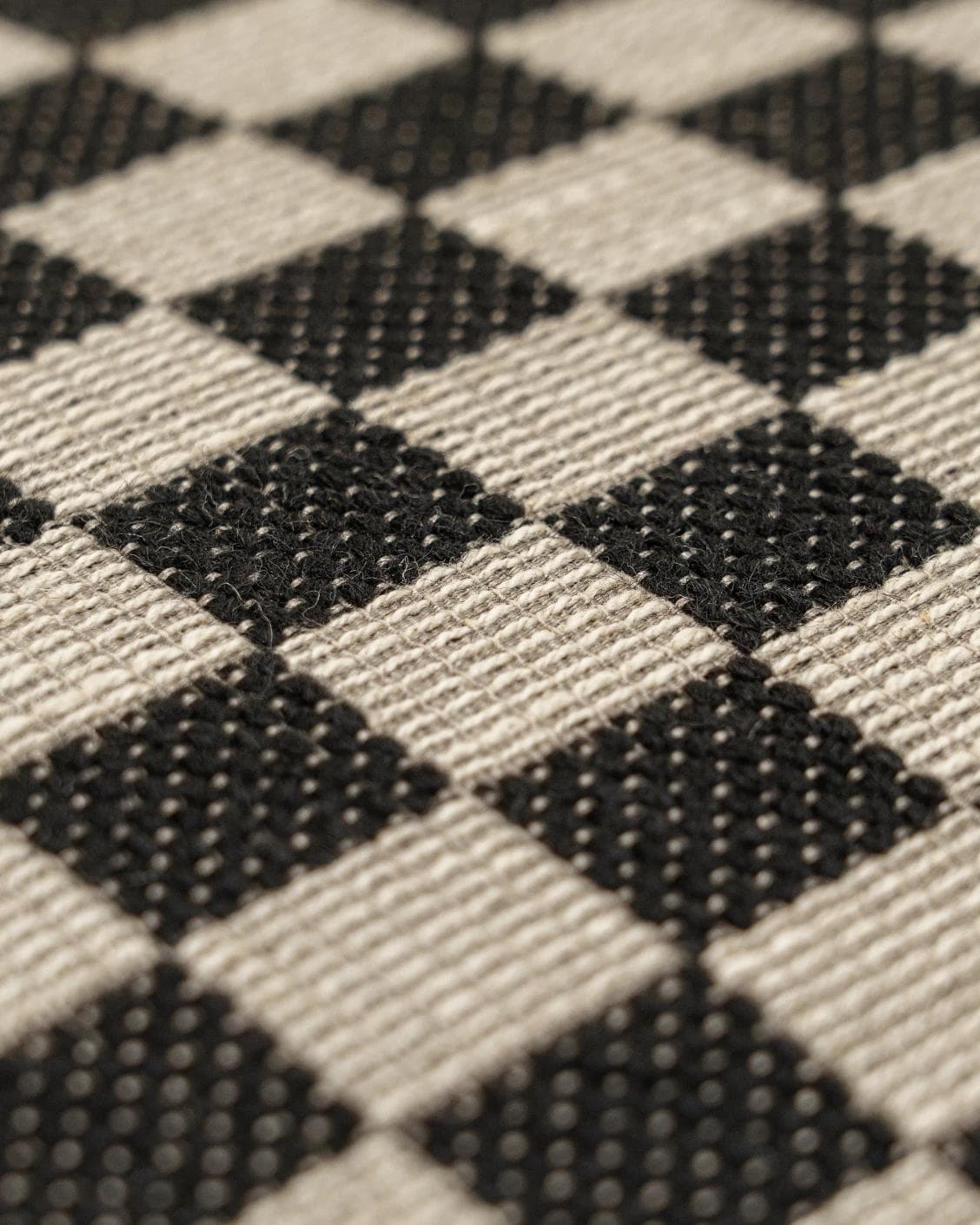 Enya Steele cushion in black and beige, shown in a product close-up as image 6