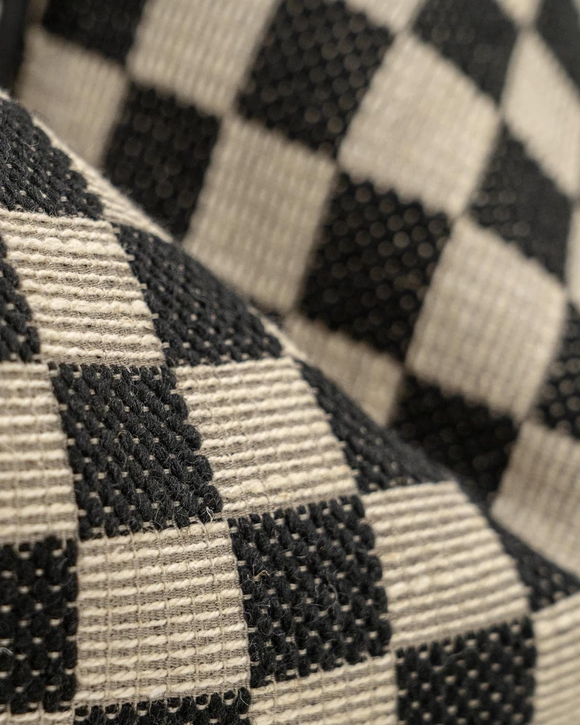 Enya Steele cushion in black and beige, shown in a product close-up as image 8
