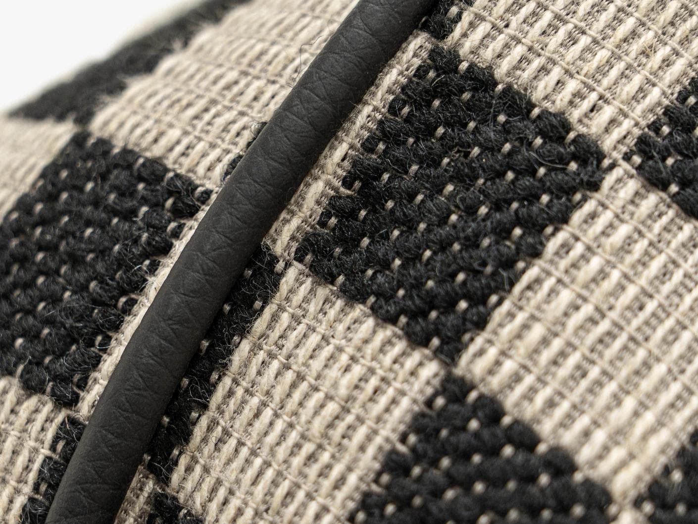 Enya Steele cushion in black and beige, shown in a product close-up as image 2