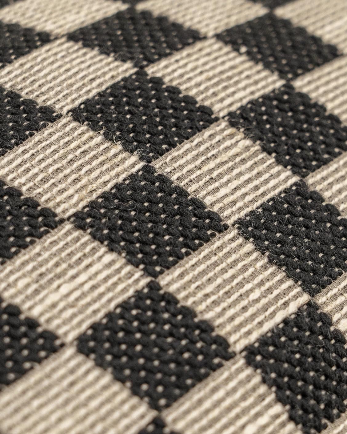 Enya Steele II cushion in black and beige, shown in a product close-up as image 4