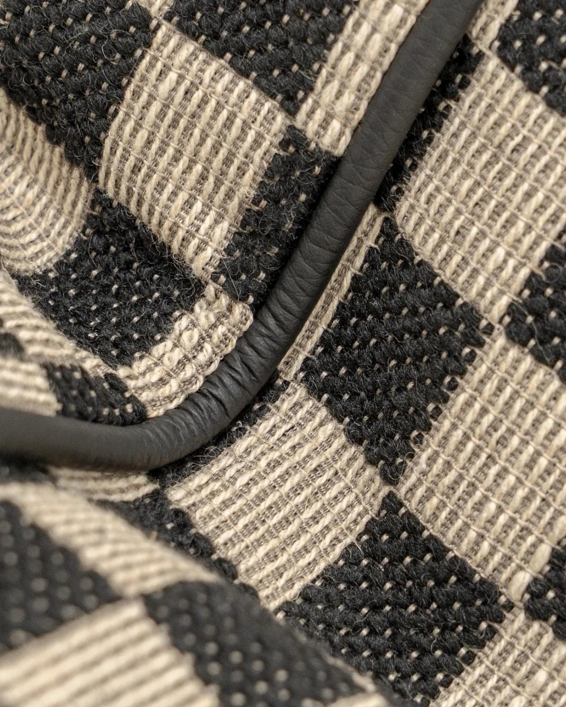 Enya Steele II cushion in black and beige, shown in a product close-up as image 5