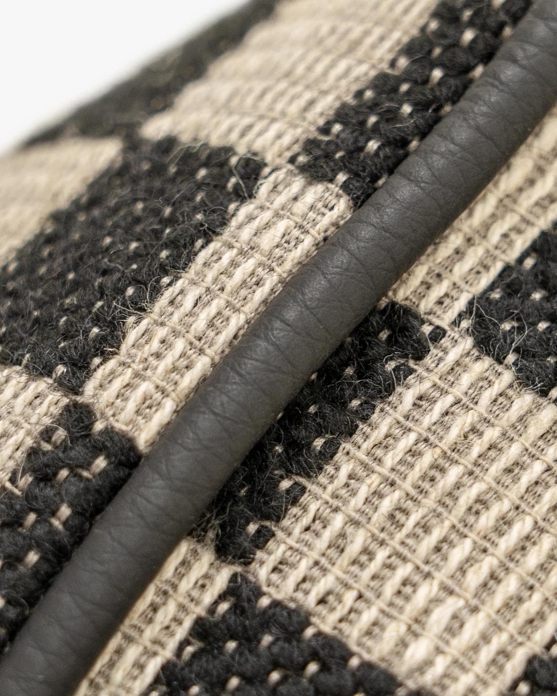 Enya Steele II cushion in black and beige, shown in a product close-up as image 7