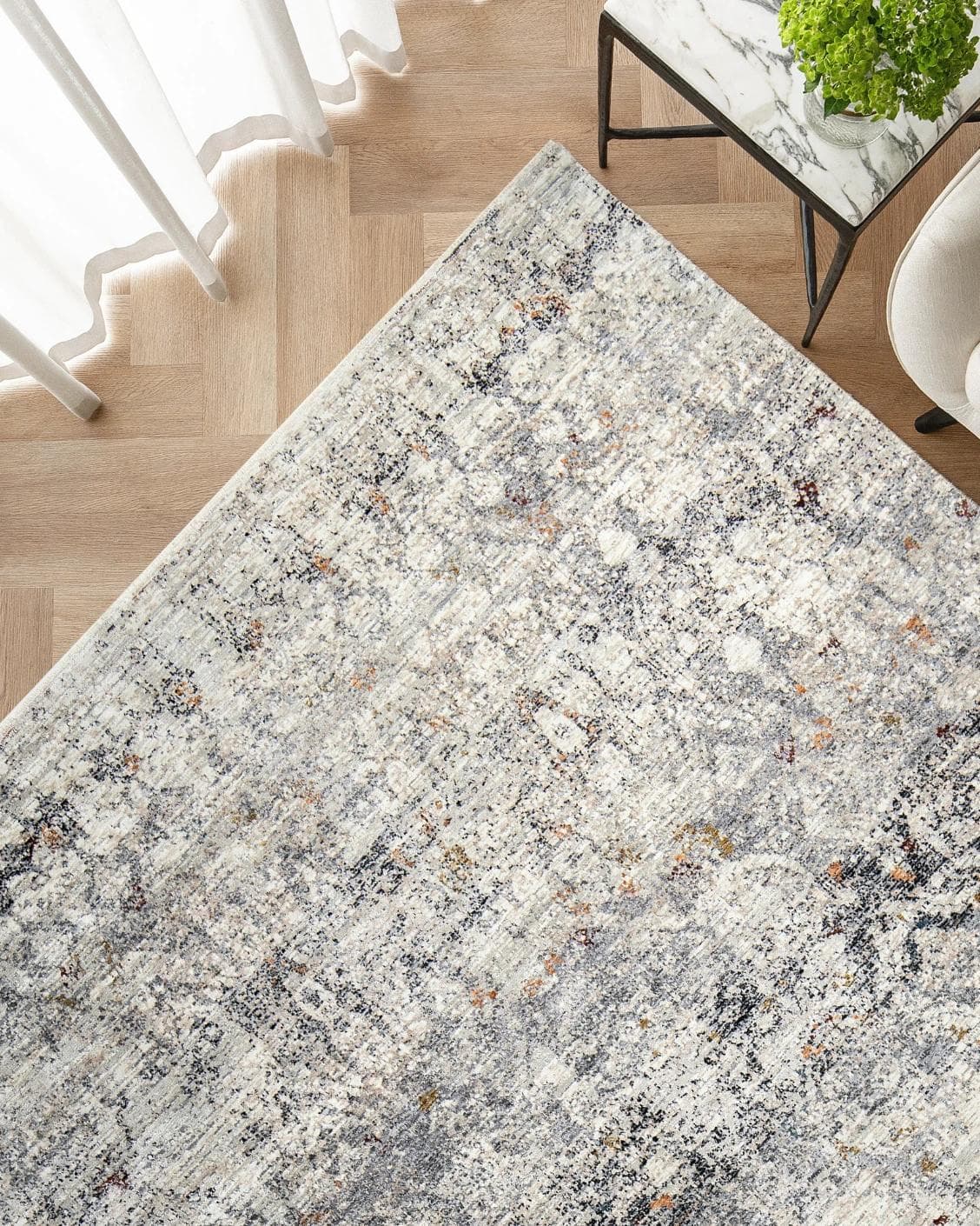 Ethan Ashton carpet in grey and beige, shown in a lifestyle top view as image 2