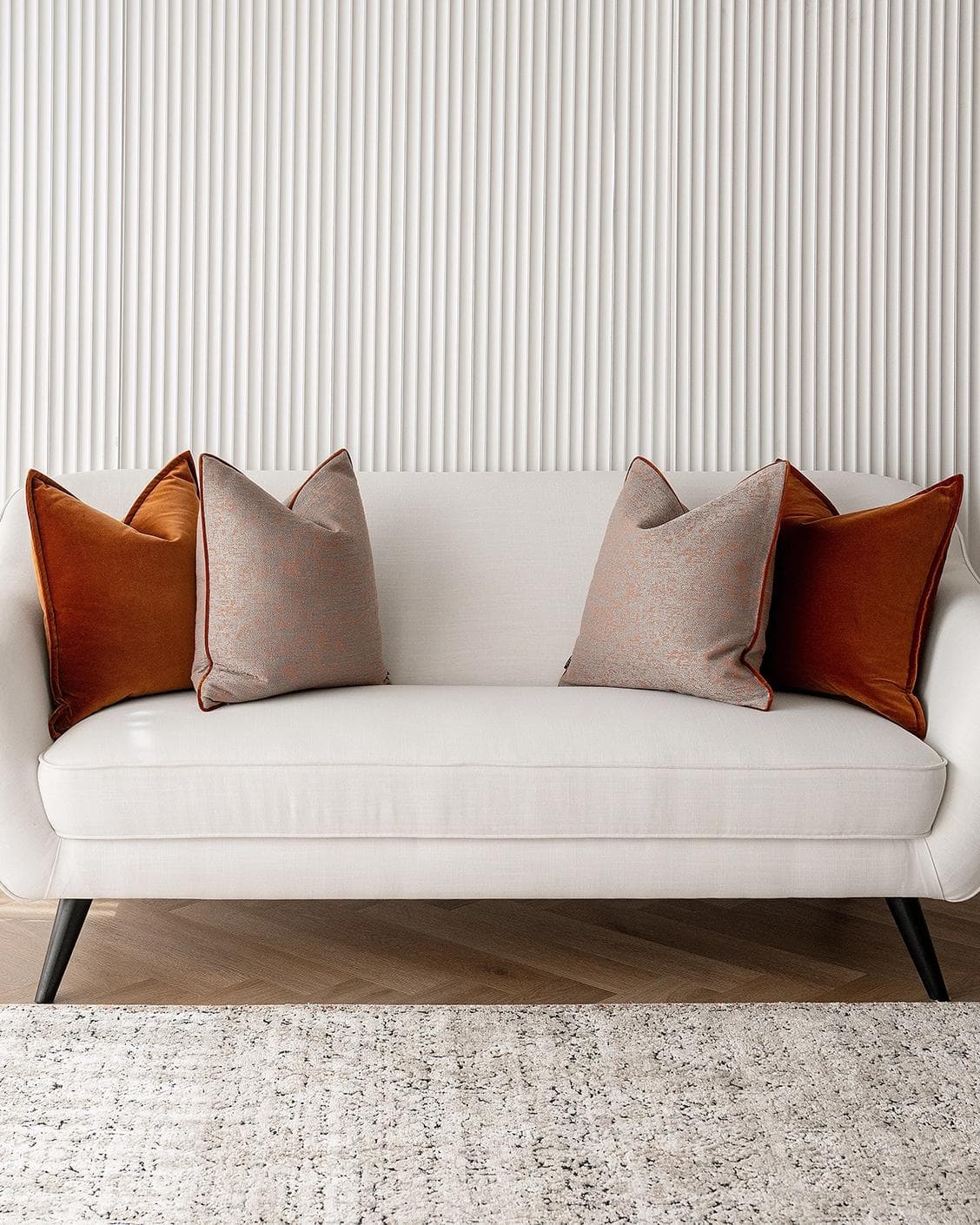 Evander Bundle cushion in rust, shown in a lifestyle front view as image 4