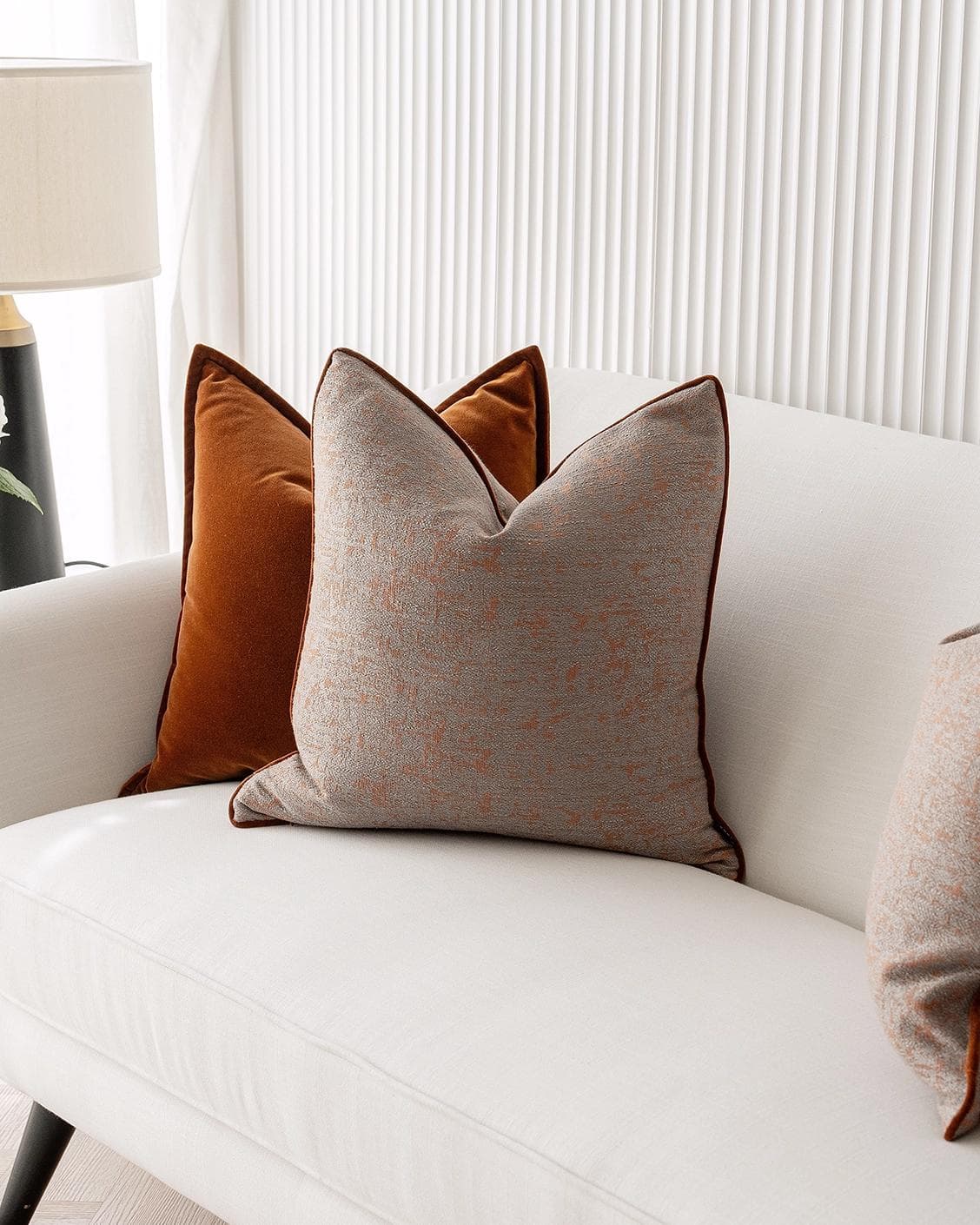 Evander Bundle cushion in rust, shown in a lifestyle right view as image 5