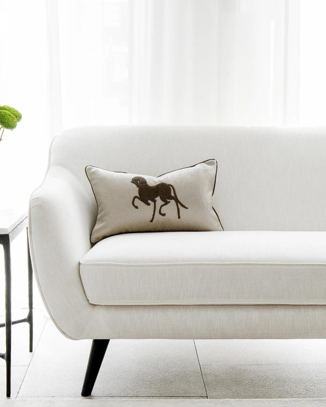Faaris Laurent cushion in brown and beige, shown in a lifestyle front view as image 4