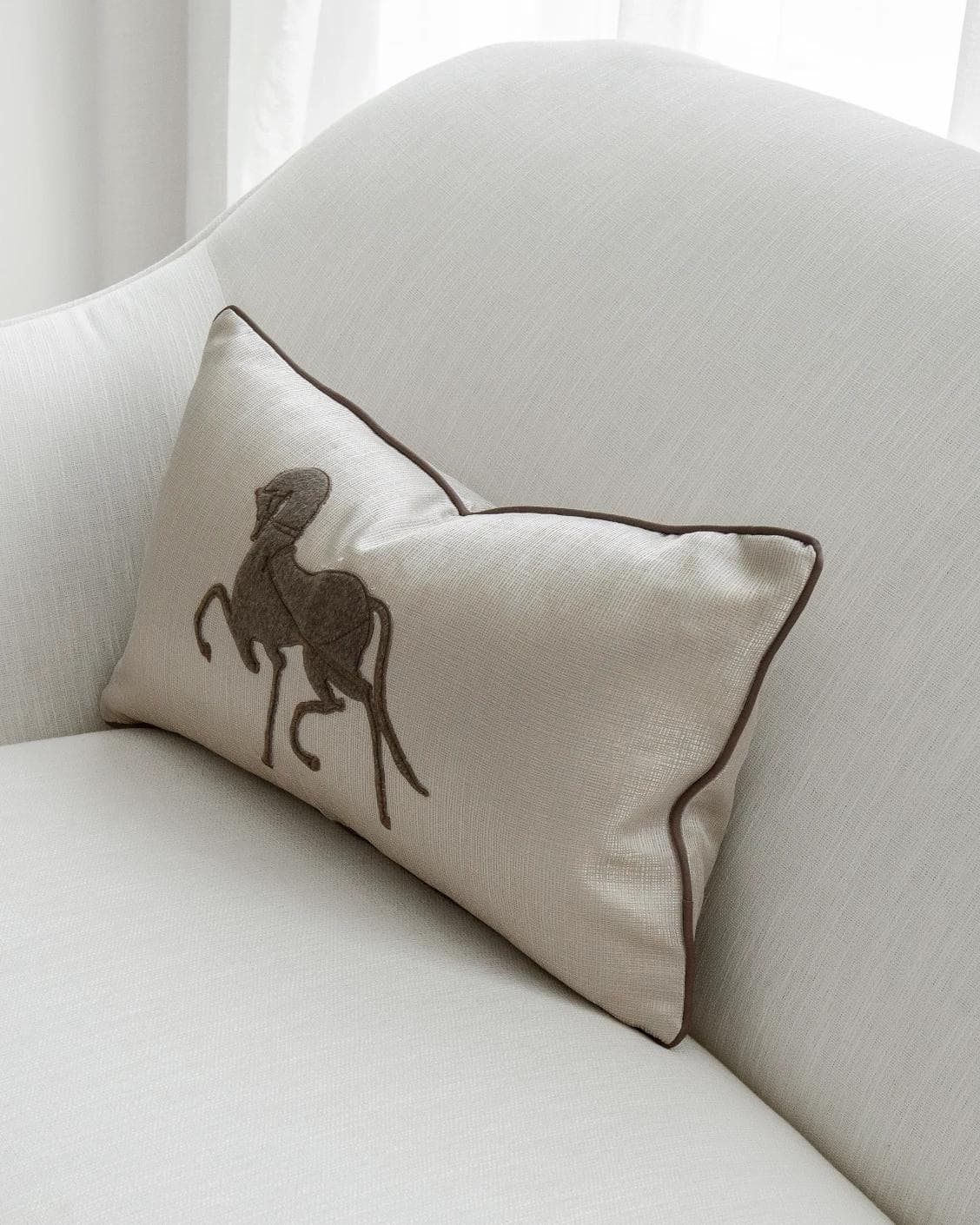 Faaris Laurent cushion in brown and beige, shown in a lifestyle right view as image 2