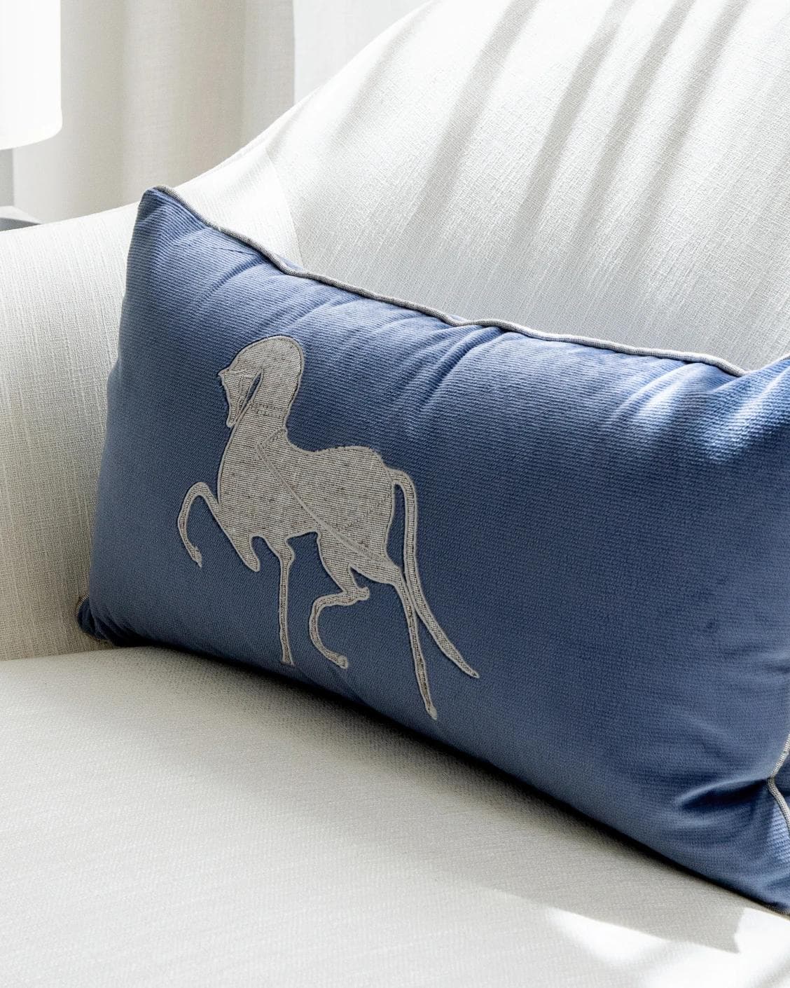 Faaris Matisse cushion in blue and silver, shown in a lifestyle right view as image 5
