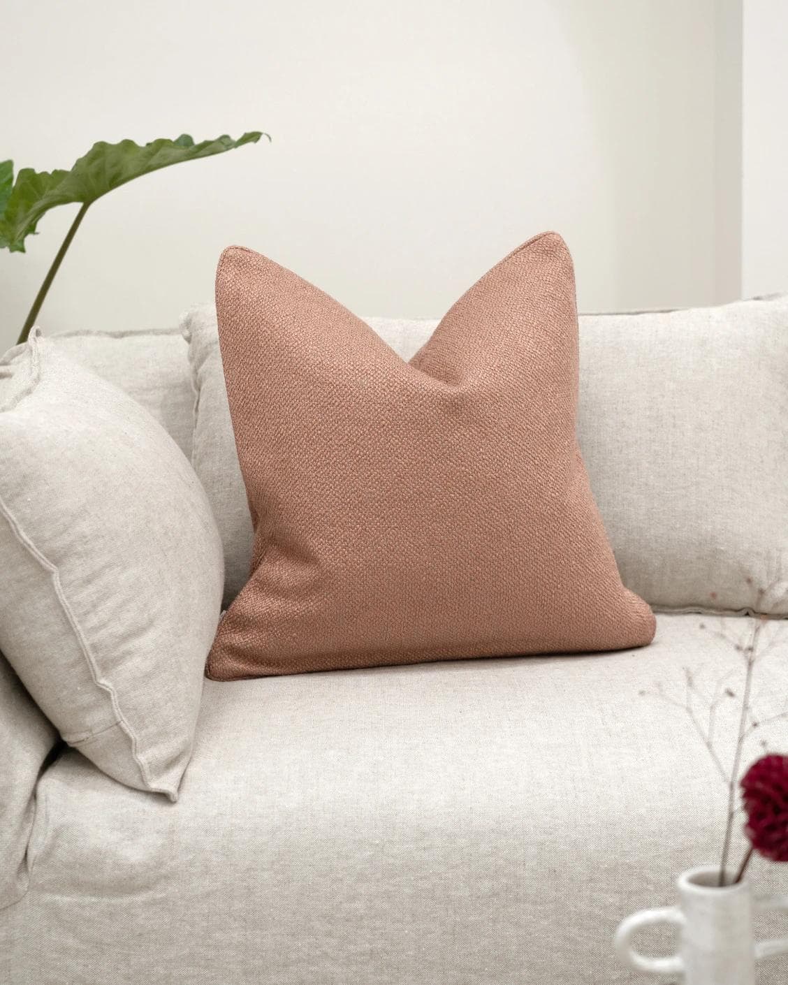 Fae Blush cushion in pink, shown in a lifestyle front view as image 2