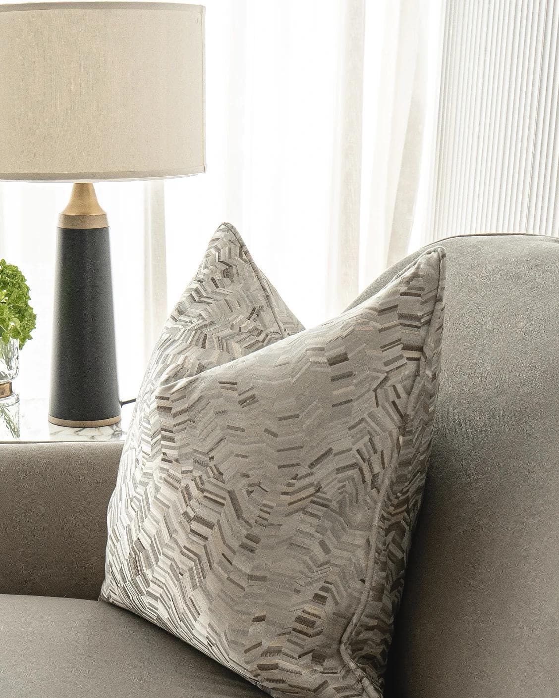 Faye Hodler cushion in silver and grey, shown in a lifestyle right view as image 5
