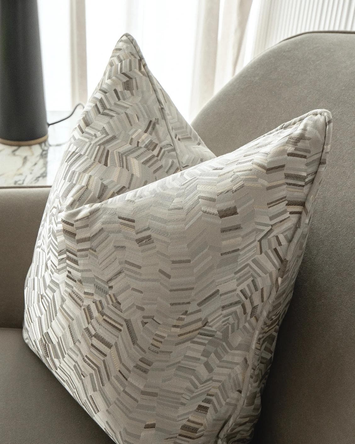 Faye Hodler cushion in silver and grey, shown in a lifestyle right view as image 6