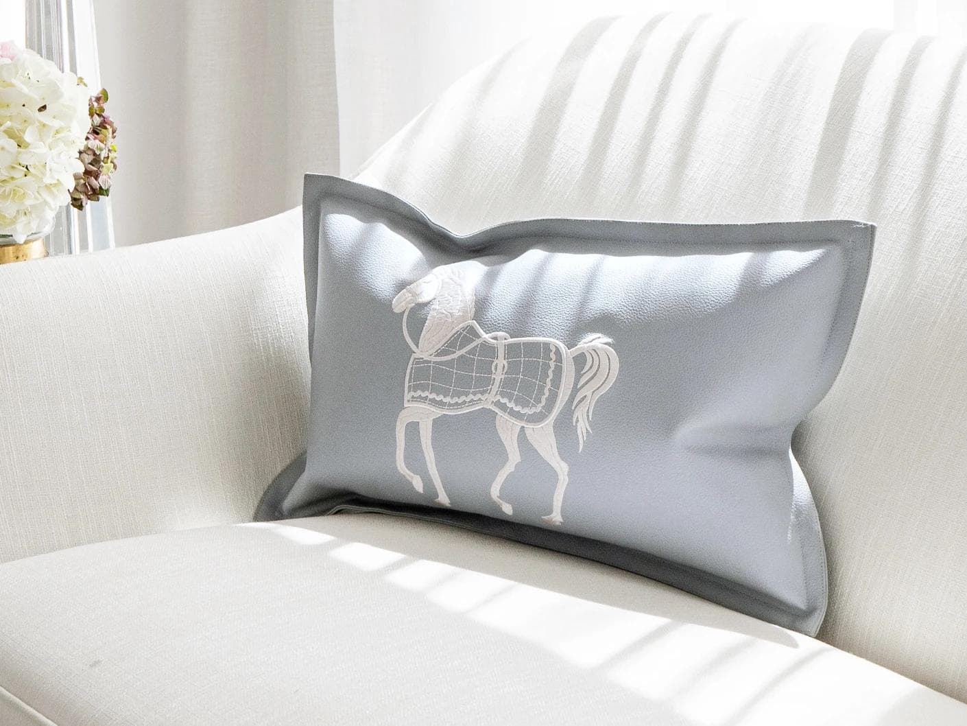 Filip Matisse cushion in blue and white, shown in a lifestyle front view as image 2