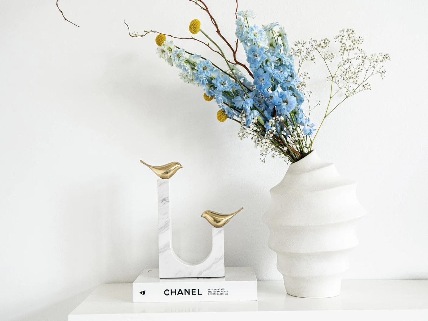 Finch Butterfield statues and sculptures in white and gold, shown in a lifestyle front view as image 3