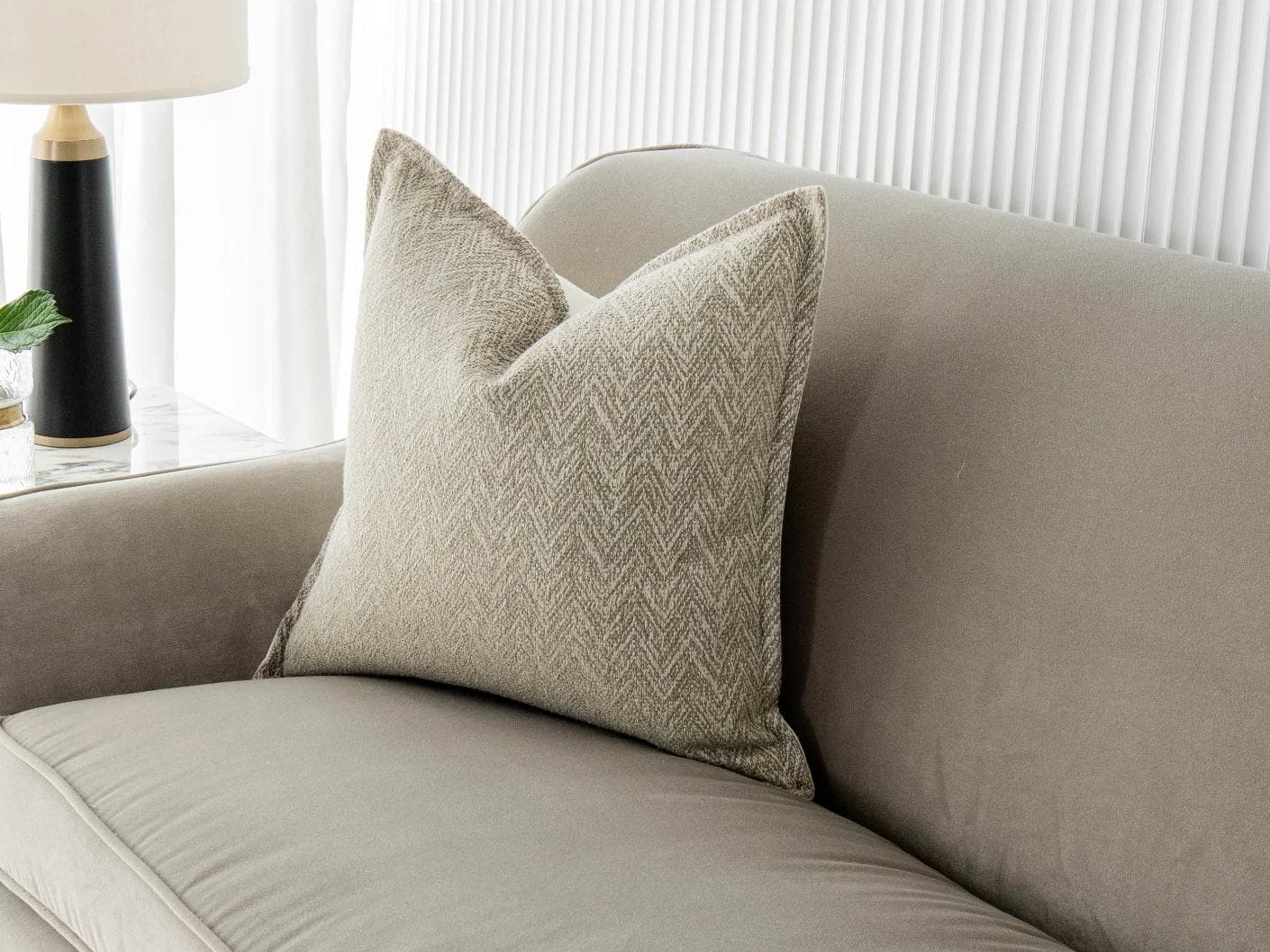 Fleur Bianca cushion in beige, shown in a lifestyle front view as image 1