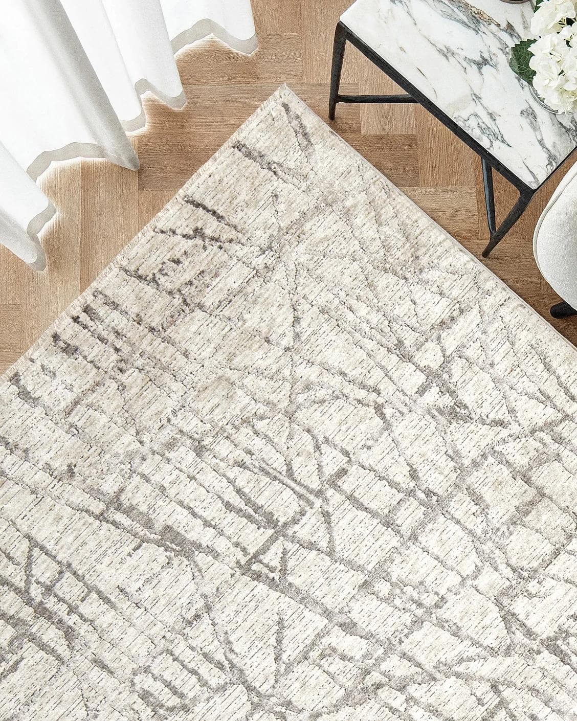 Freida Ashley carpet in grey and beige, shown in a lifestyle top view as image 2
