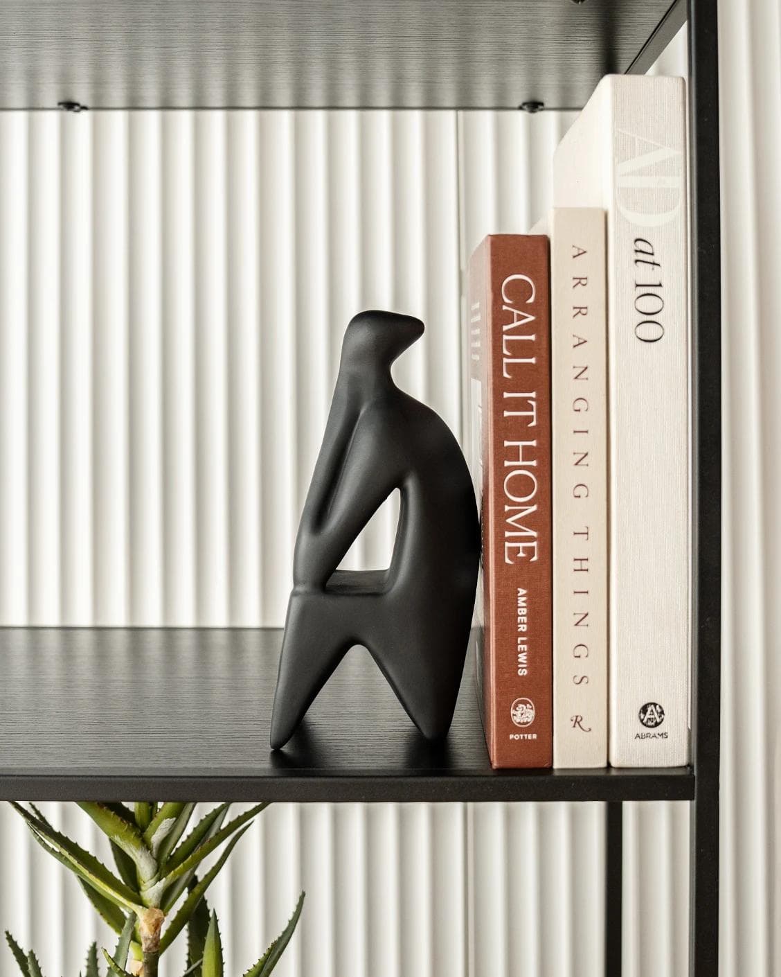 Hakim Arneson statues and sculptures in black, shown in a lifestyle front view as image 2
