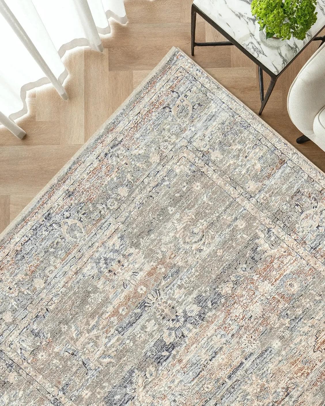 Hana Dune carpet in beige and rust, shown in a lifestyle top view as image 2